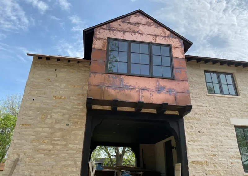 Copper metal panel facade on a stone building for Skylight Installation in Sheridan